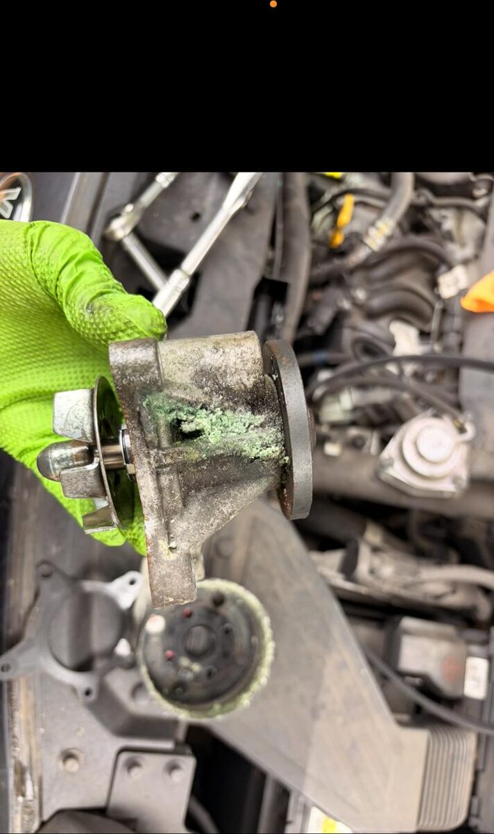 Old water pump removed showing coolant deposits