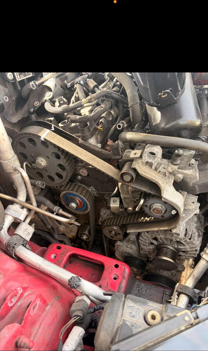 New timing belt, tensioner and pulleys fitted to an engine