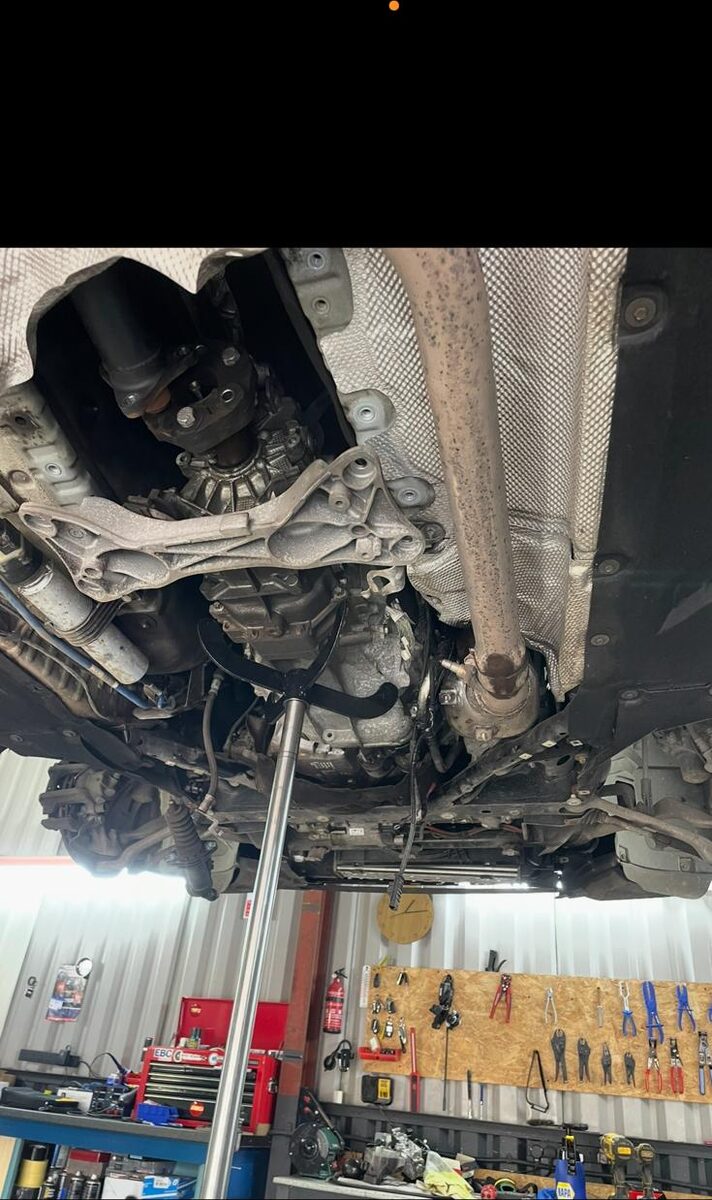 Car raised on the ramp inside the workshop at Iver