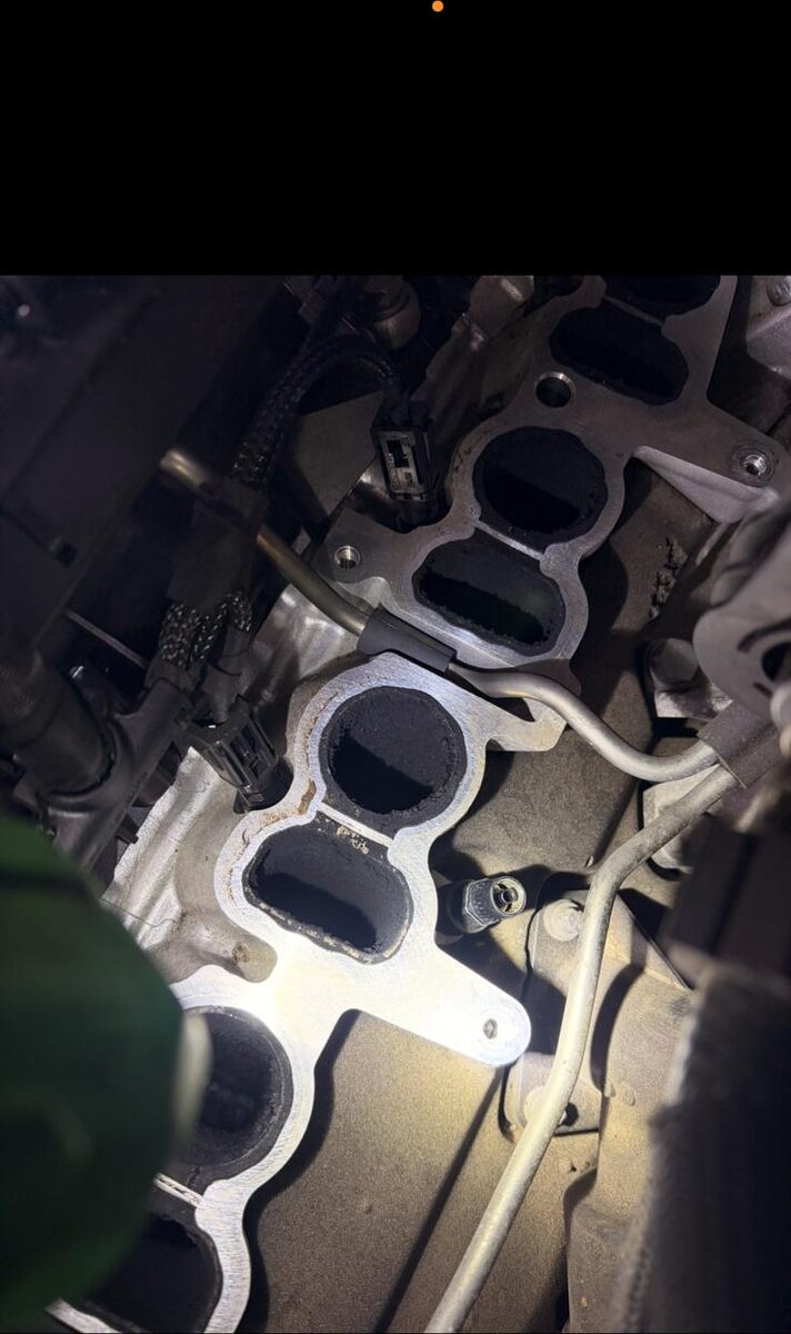 Inlet manifold ports on a cylinder head coated in soot